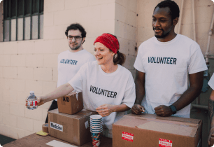 A group of volunteers standing sharing products.